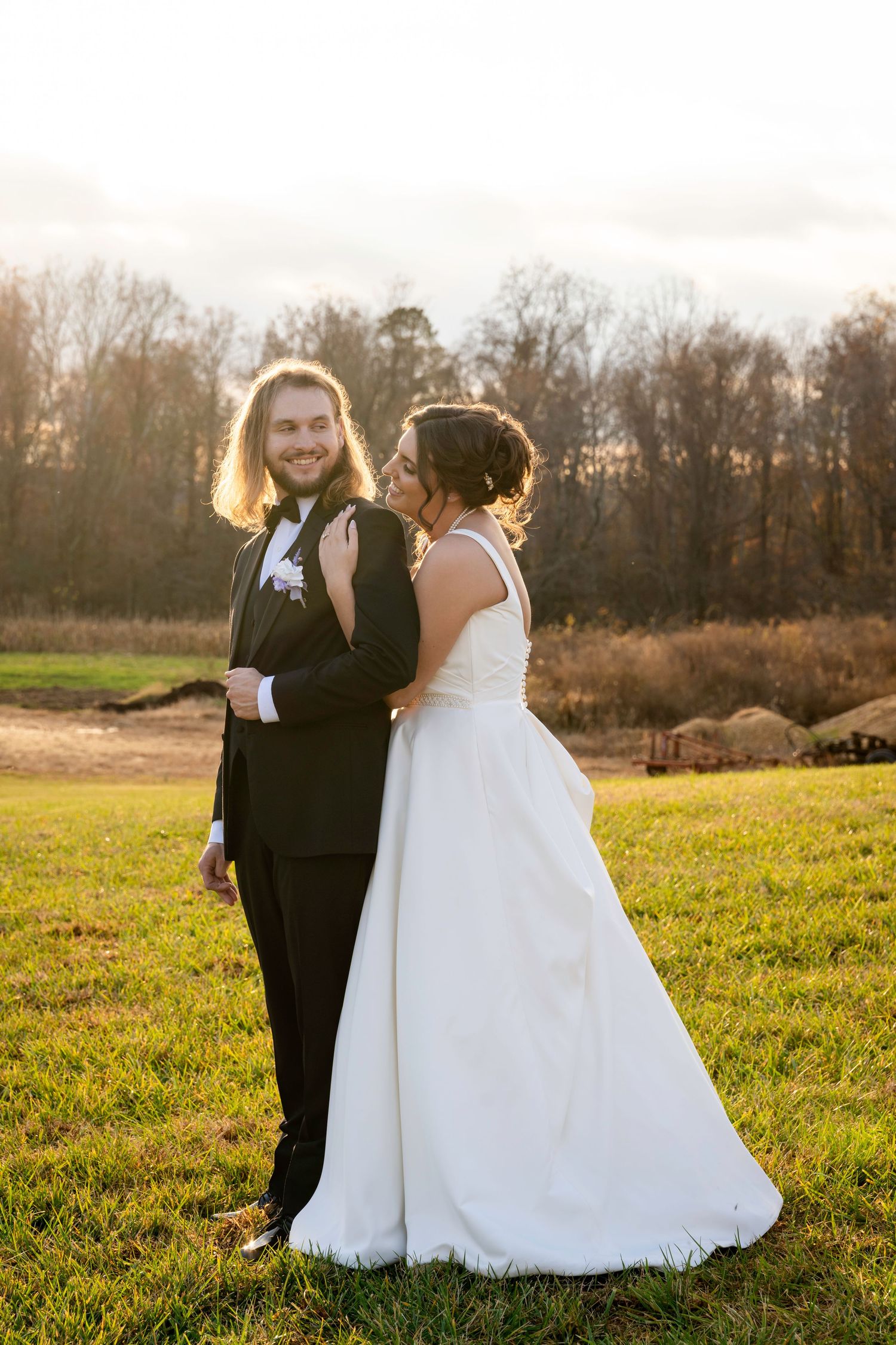 Bride and groom laughing together during intimate sunset wedding portraits.